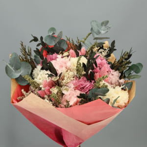 Ramo de flores preservadas Vega Rosa Claro con hortensias en tonos rosa y crema, espigas rosadas y ramas verdes de eucalipto.